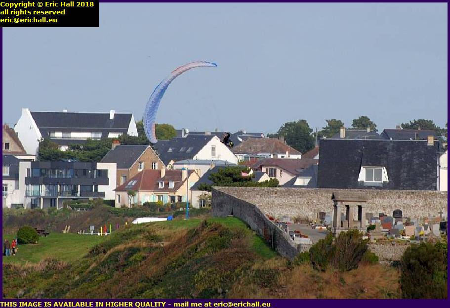 hang gliders performing aerobics over cemetery granville manche normandy france