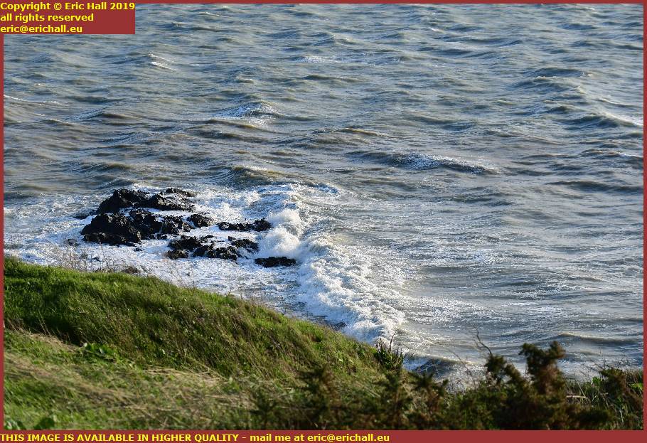 waves crashing on rocks pointe du roc granville manche normandy france