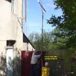 Les Guis Virlet Pionsat France Renewable Energy screwing the pole to the fence